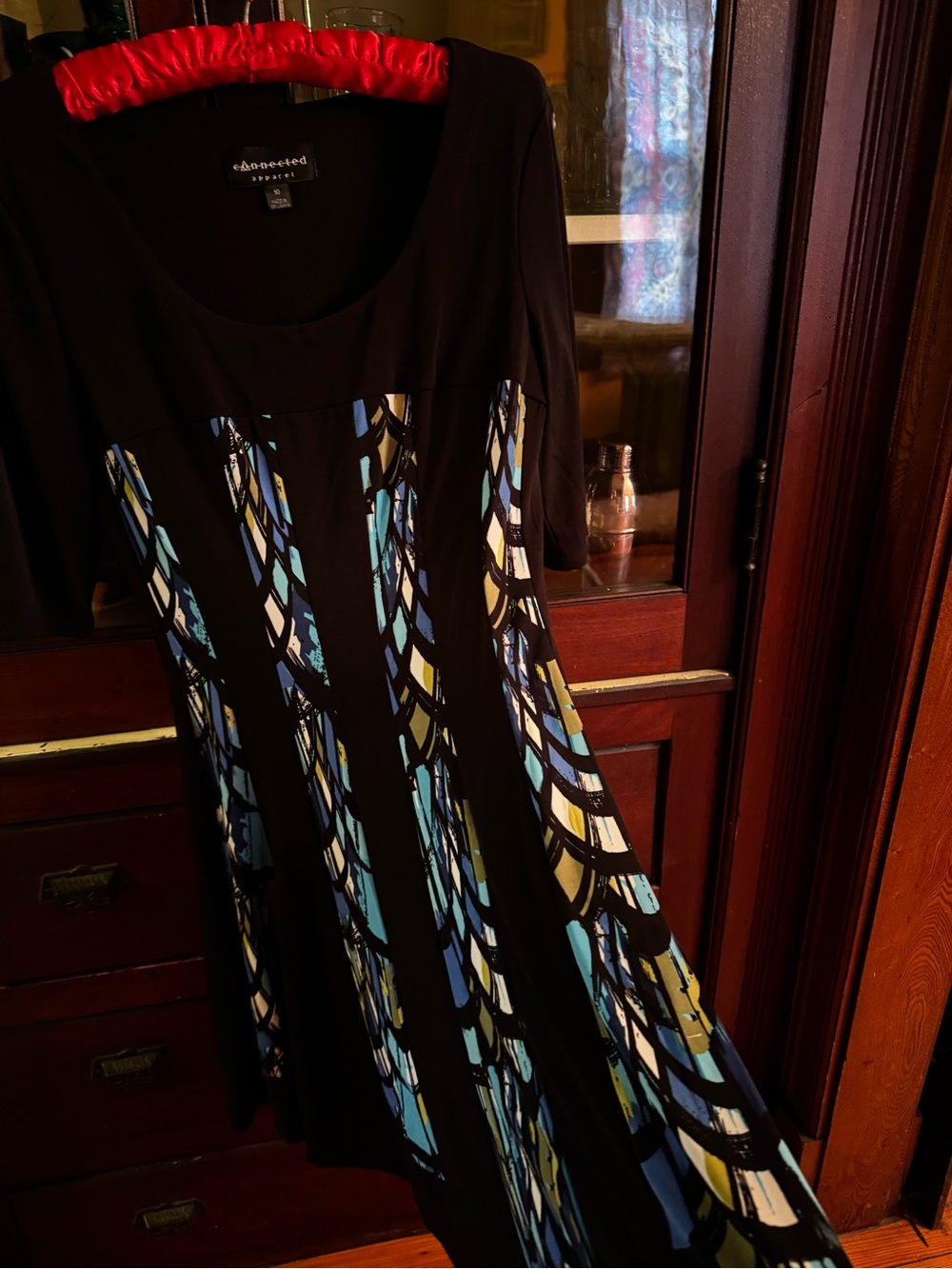 connected apparel Black Dress with stained glass looking colorful panels.